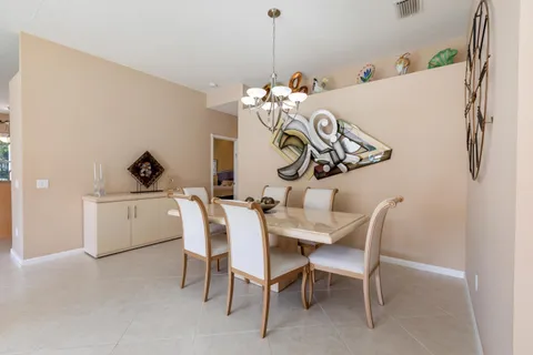 a view of a dining room with furniture and front door