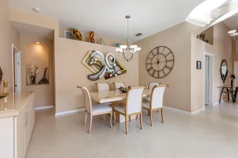 a dining room with furniture and a large window