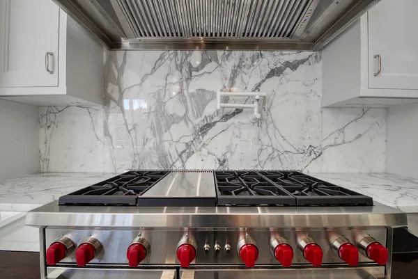 a kitchen with a table chairs stove and wooden floor