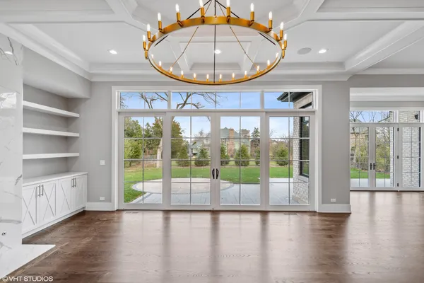 a view of empty room with wooden floor and fireplace