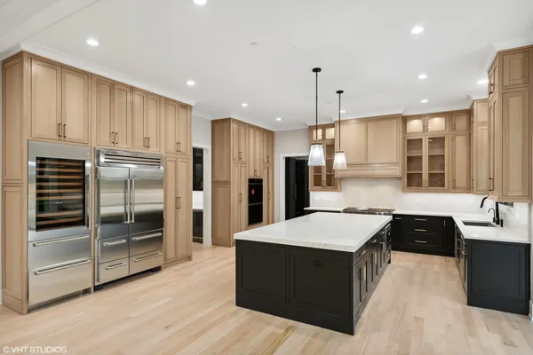 a spacious kitchen with stainless steel appliances granite countertop a sink a oven and a large window