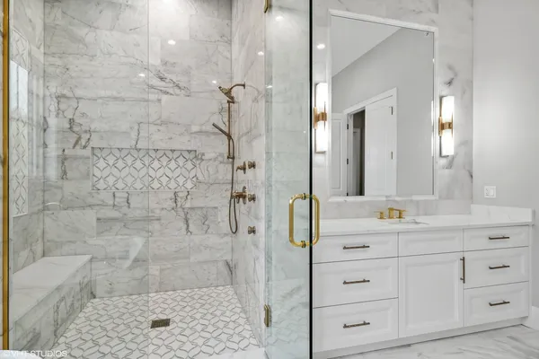 a bathroom with a sink a mirror and a shower