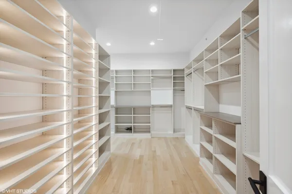 a kitchen with white cabinets and a refrigerator