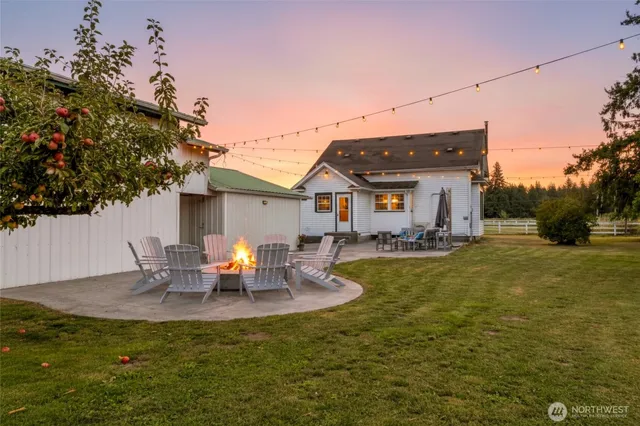 a view of a house with backyard and sitting area