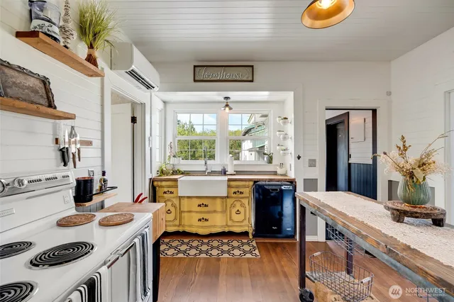 a kitchen with a stove a sink and a refrigerator