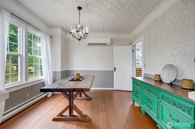 a room with chandelier fan and wooden floor