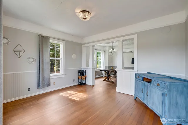 an empty room with furniture and windows