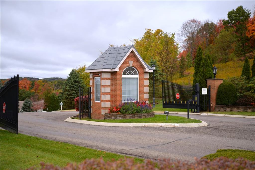 509 Madison Boulevard Freedom, PA 15042 - Photo 37 of 41 a front view of a house with a yard and fountain in middle