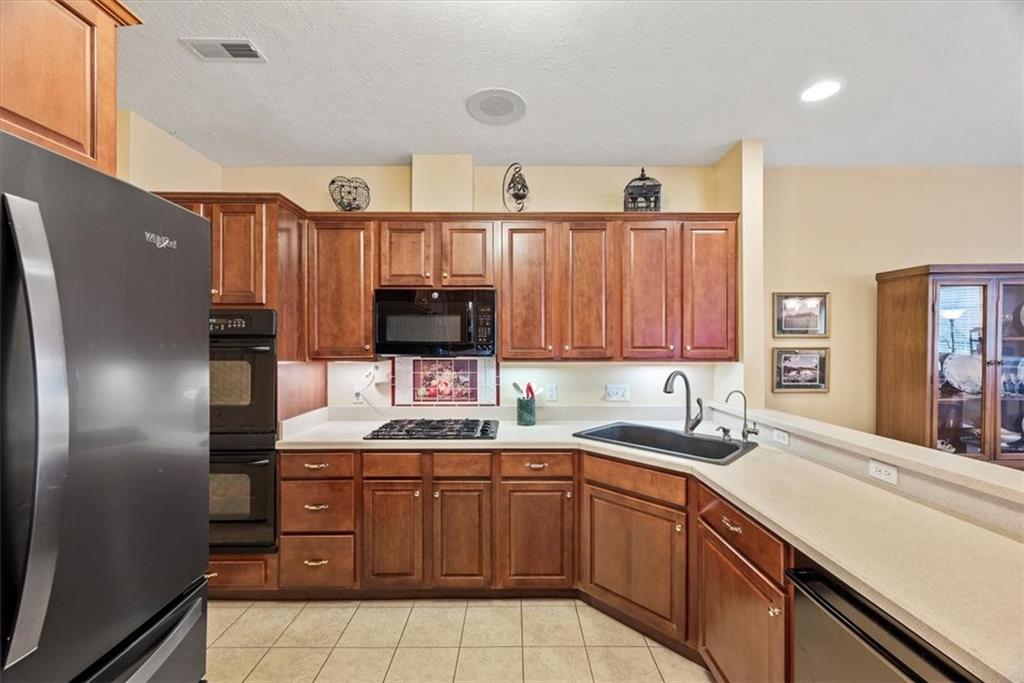 509 Madison Boulevard Freedom, PA 15042 - Photo 10 of 41 a kitchen with a sink a refrigerator and cabinets
