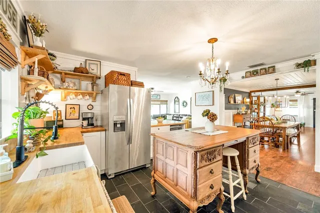 a view of a kitchen with dining table and chairs