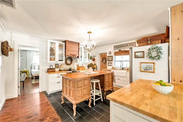 a living room with granite countertop furniture a dining table and chairs with wooden floor