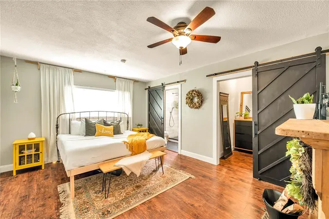 a bedroom with furniture and a large window