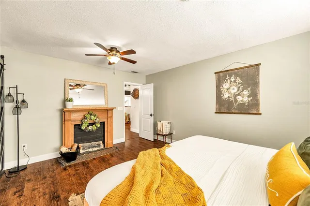 a bedroom with bed and a fireplace