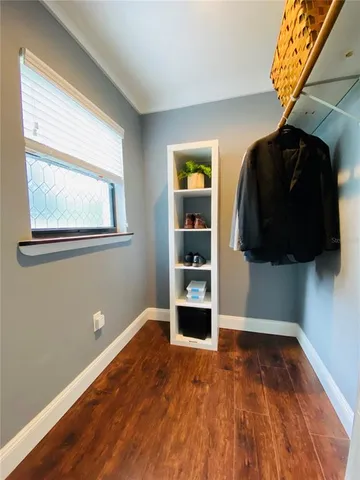 a view of walk in closet with clothes and shoes