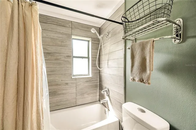 a bathroom with a toilet and shower