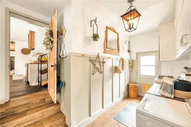 a view of washer and dryer with kitchen view