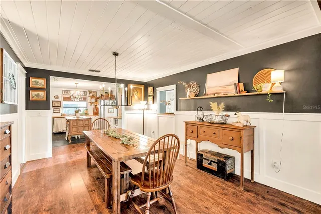 a dining room with furniture and wooden floor