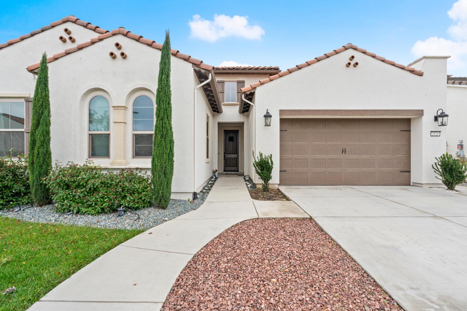 2826 Cameo Street Lodi, CA 95242 - Photo 13 of 52 a view of a white house with a small yard and a large window