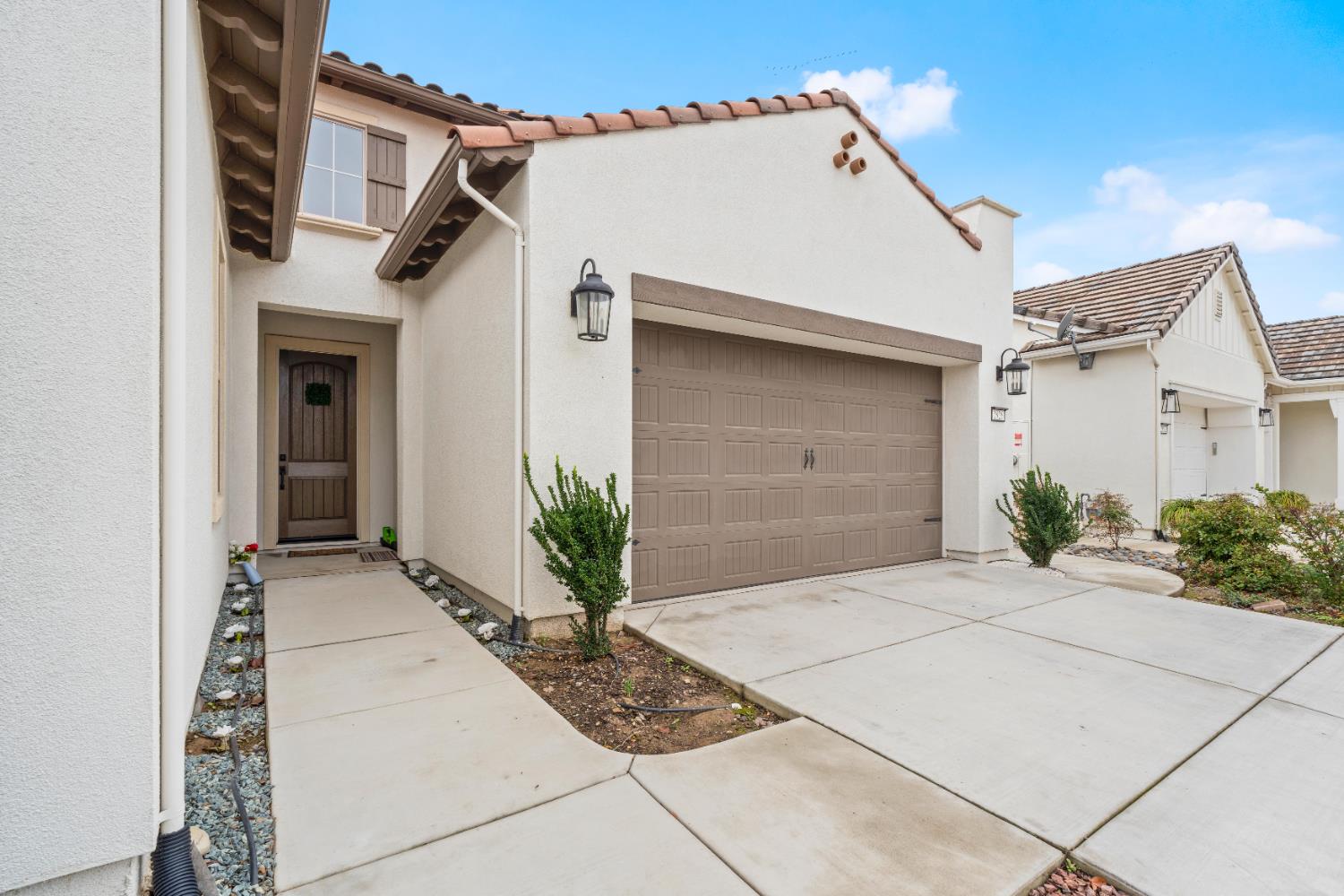 2826 Cameo Street Lodi, CA 95242 - Photo 14 of 52 a white house with potted plants in front of it