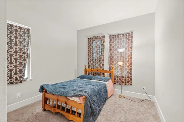 a bedroom with a bed and window