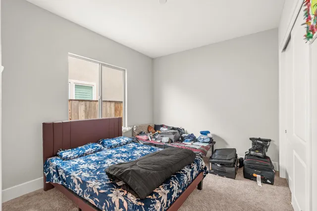 a bedroom with a bed and a dresser