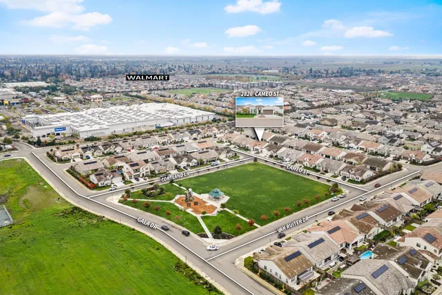 an aerial view of a residential houses with outdoor space