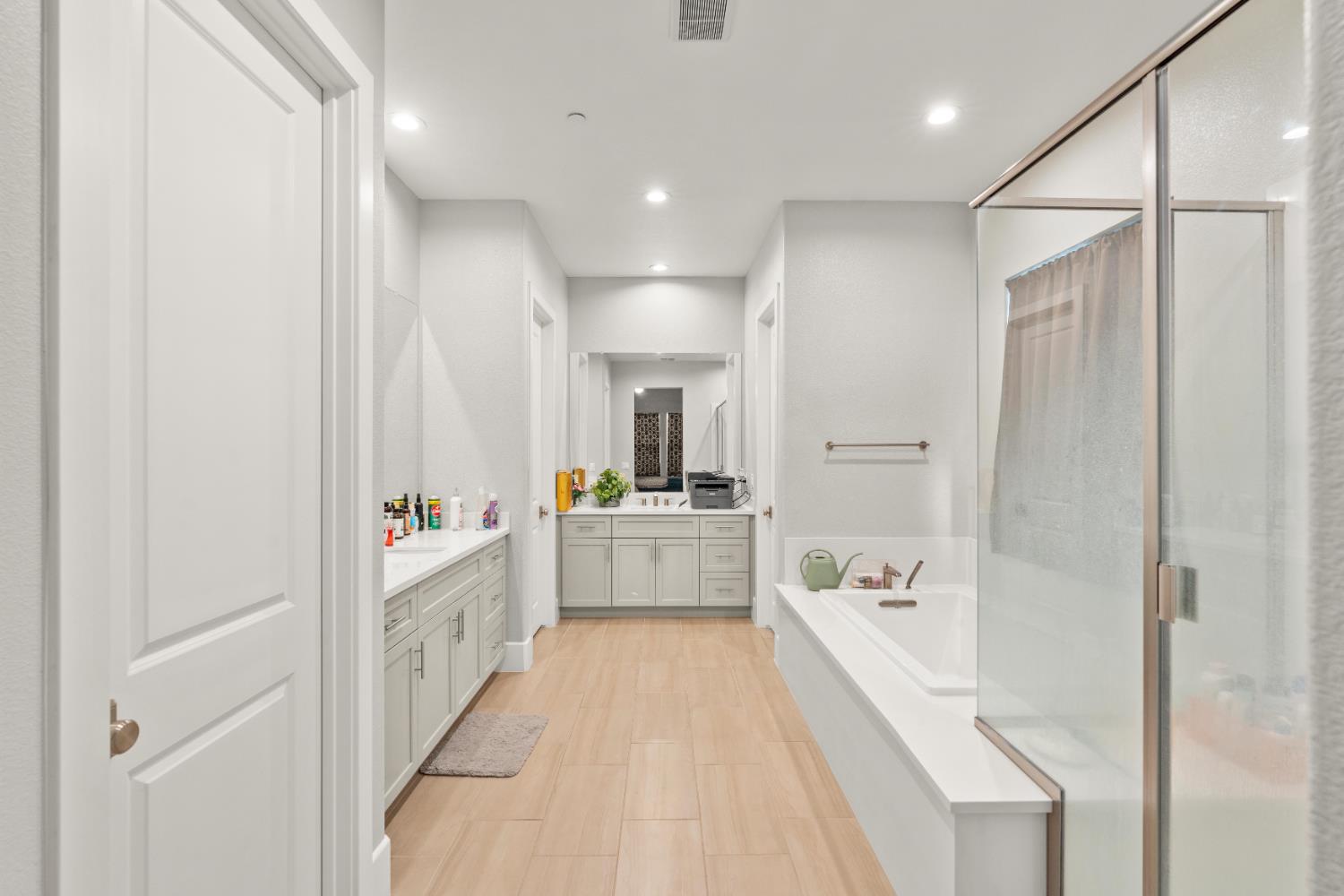 2826 Cameo Street Lodi, CA 95242 - Photo 45 of 52 a bathroom with a tub a sink and a large mirror