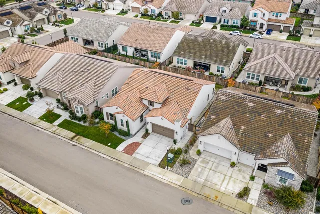 an aerial view of multiple houses with a street