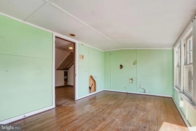 a view of empty room with wooden walls