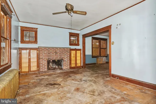 a view of empty room with fireplace and fan