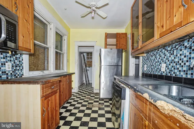 a kitchen with granite countertop a refrigerator and a stove