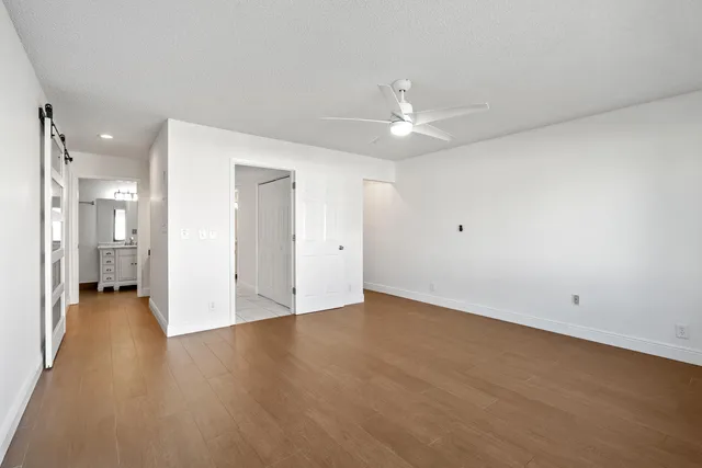 a spacious bedroom with a bed and furniture
