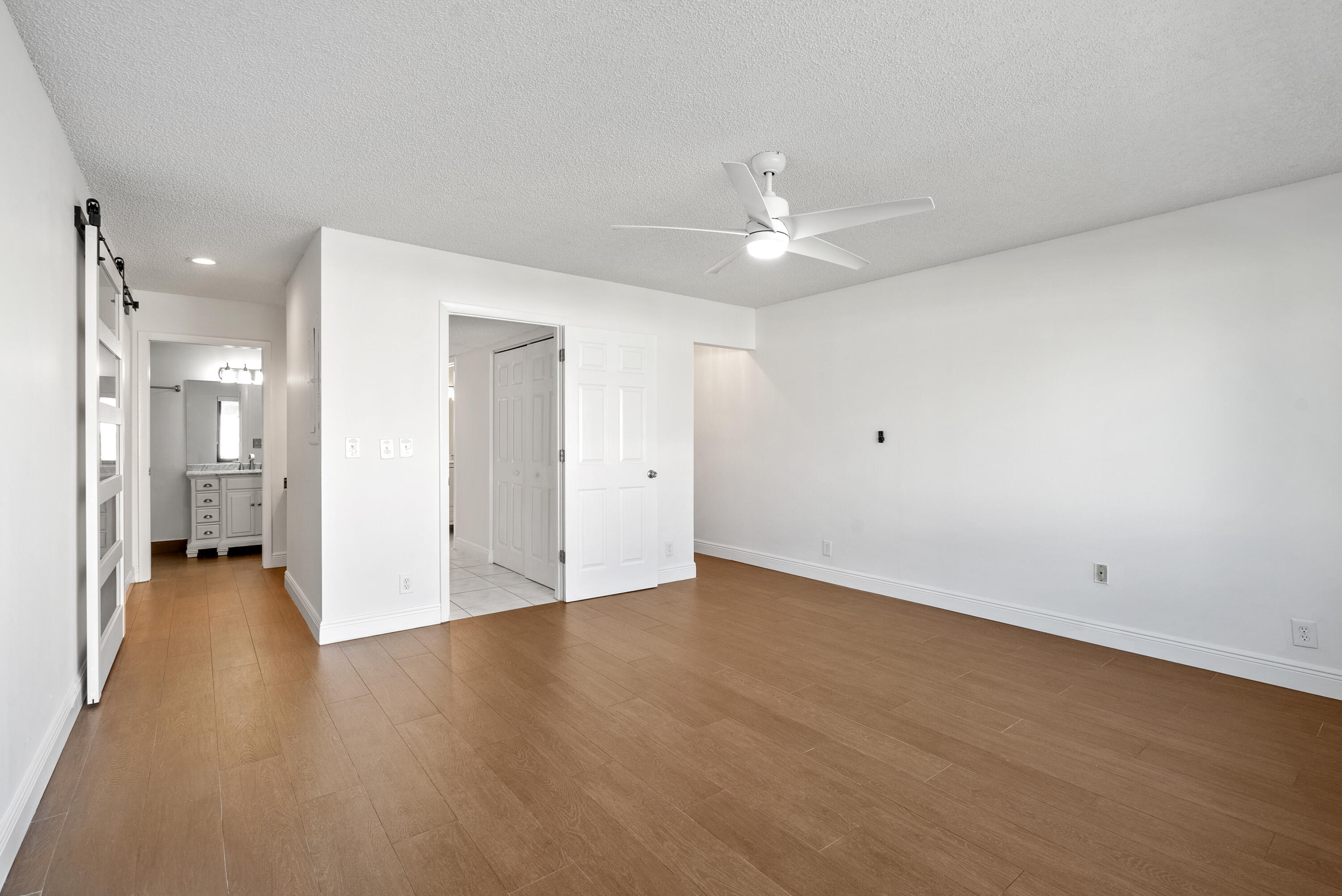 5110 Nesting Way, Unit B Delray Beach, FL 33484 - Photo 16 of 29 an empty room with a bathroom and a ceiling fan