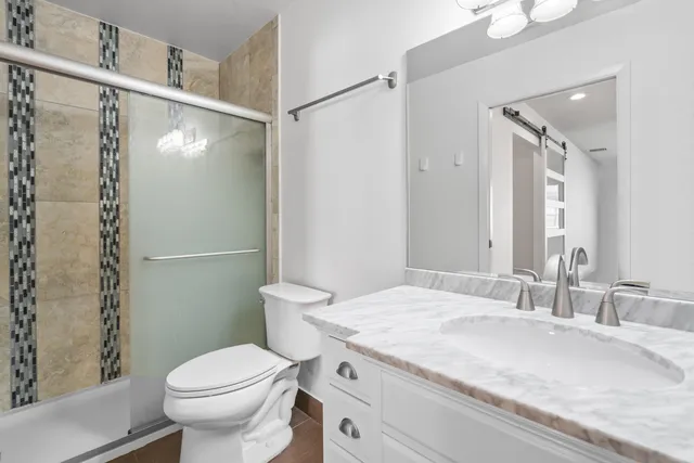a bathroom with a shower and toilet