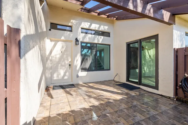 a view of backyard with tub and tree
