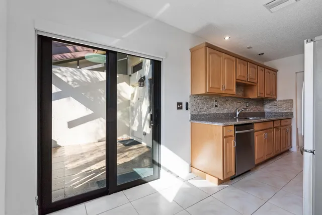 a kitchen with stainless steel appliances granite countertop a stove top oven a sink and a granite counter top