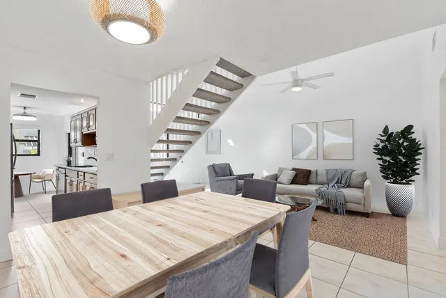 a large bedroom with wooden floor and furniture
