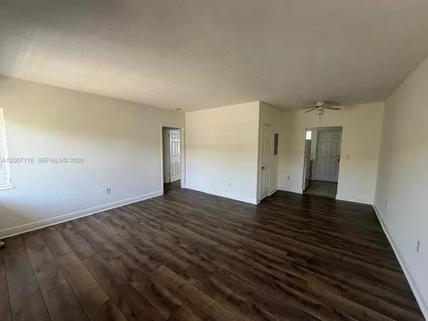a view of an empty room and wooden floor