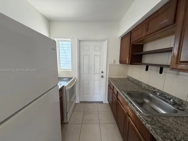a kitchen with a stove and a refrigerator