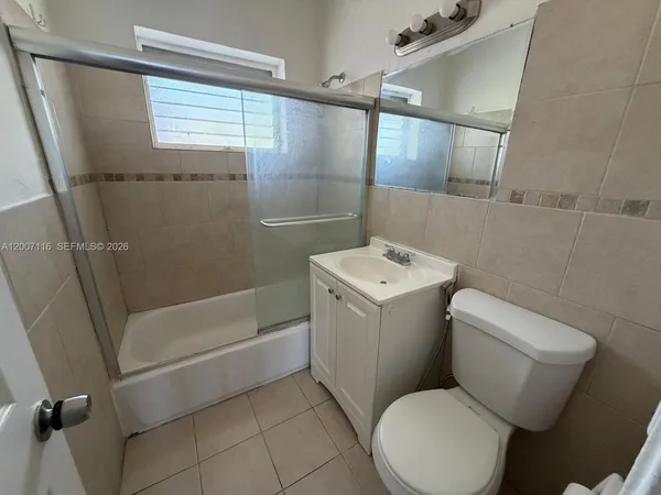 a bathroom with a toilet sink and shower