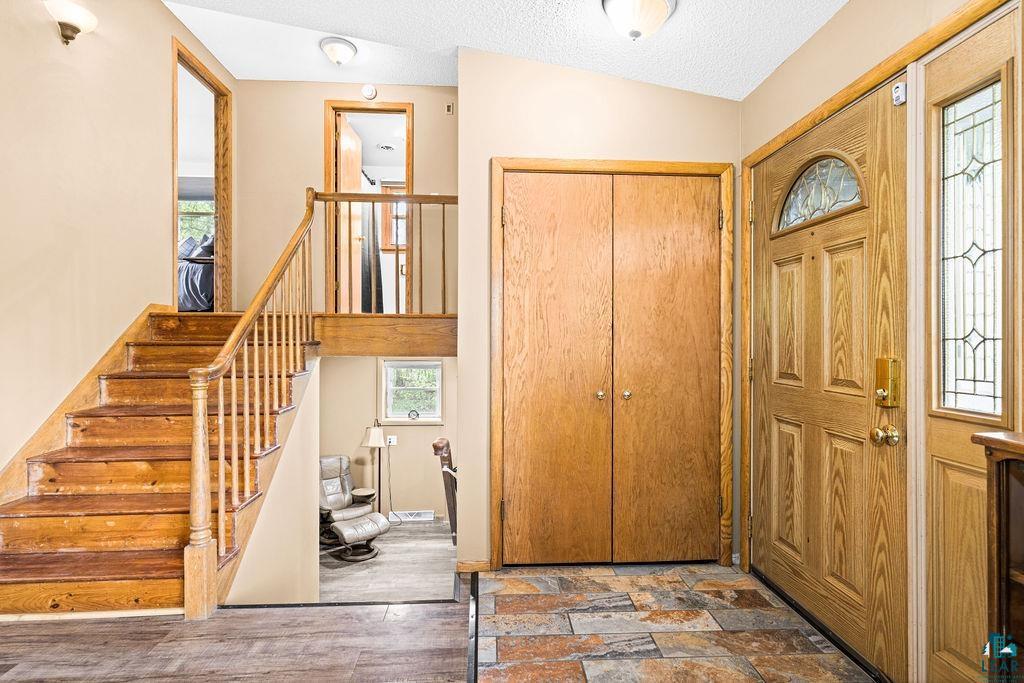 20 Canosia Road Esko, MN 55733 - Photo 3 of 29 Sitting room with wood finished floors, a fireplace, baseboards, and lofted ceiling
