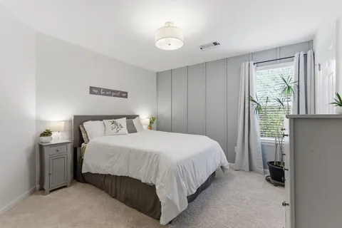 a bedroom with a bed and a window