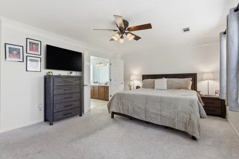 a bedroom with a bed dresser and a window