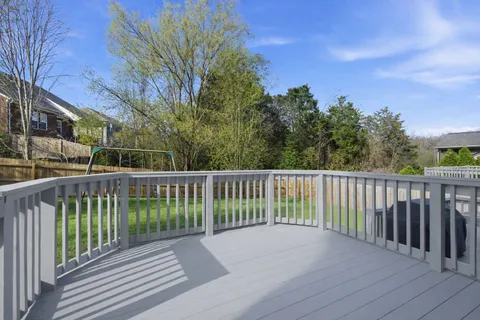 a view of a backyard with a small barn and wooden fence
