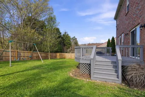 a view of a house with wooden fence