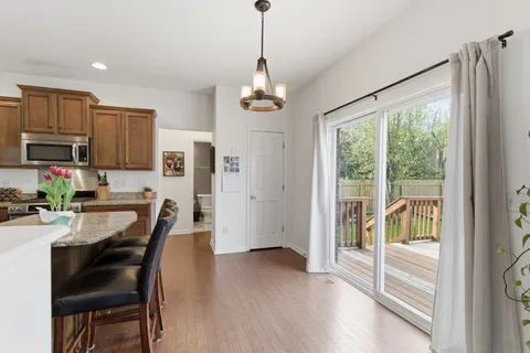 a dining room with furniture a chandelier and wooden floor