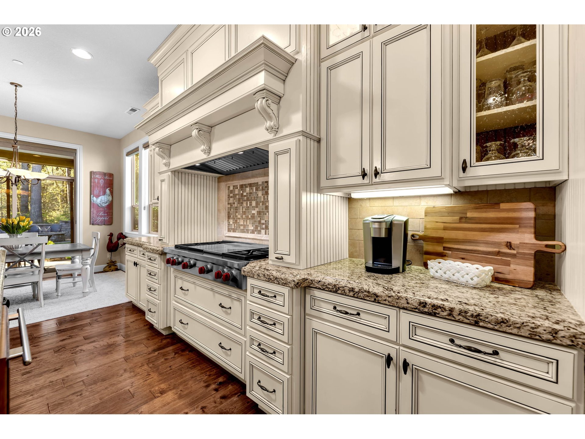 806 Northwest 35th Avenue Camas, WA 98607 - Photo 13 of 48 a kitchen with granite countertop a stove a chimney a sink and wooden cabinets