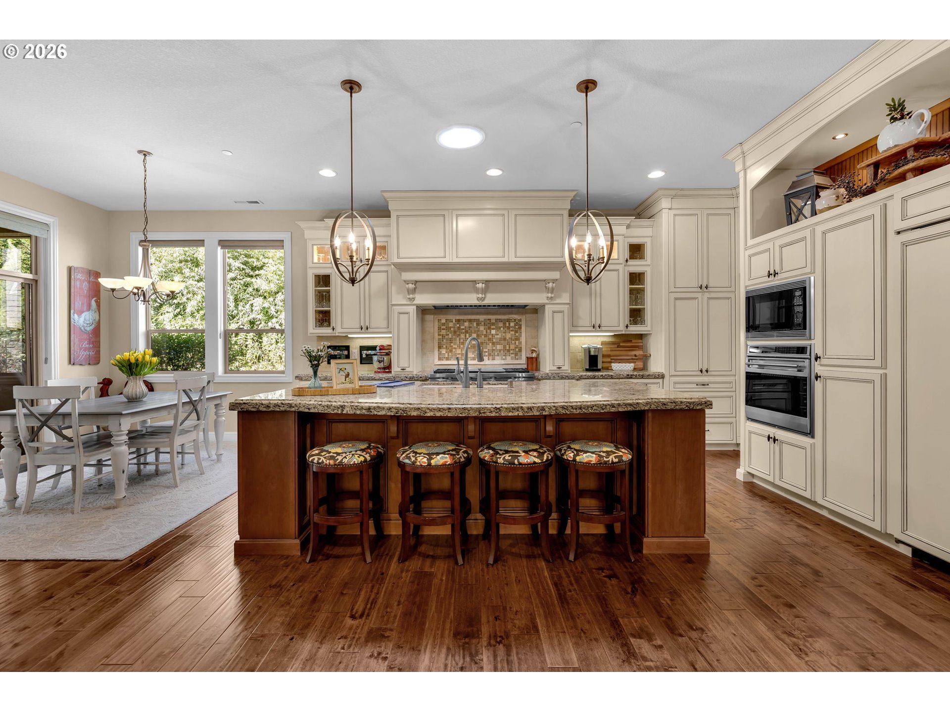 806 Northwest 35th Avenue Camas, WA 98607 - Photo 14 of 48 a kitchen with stainless steel appliances granite countertop wooden floor refrigerator dining table and chairs