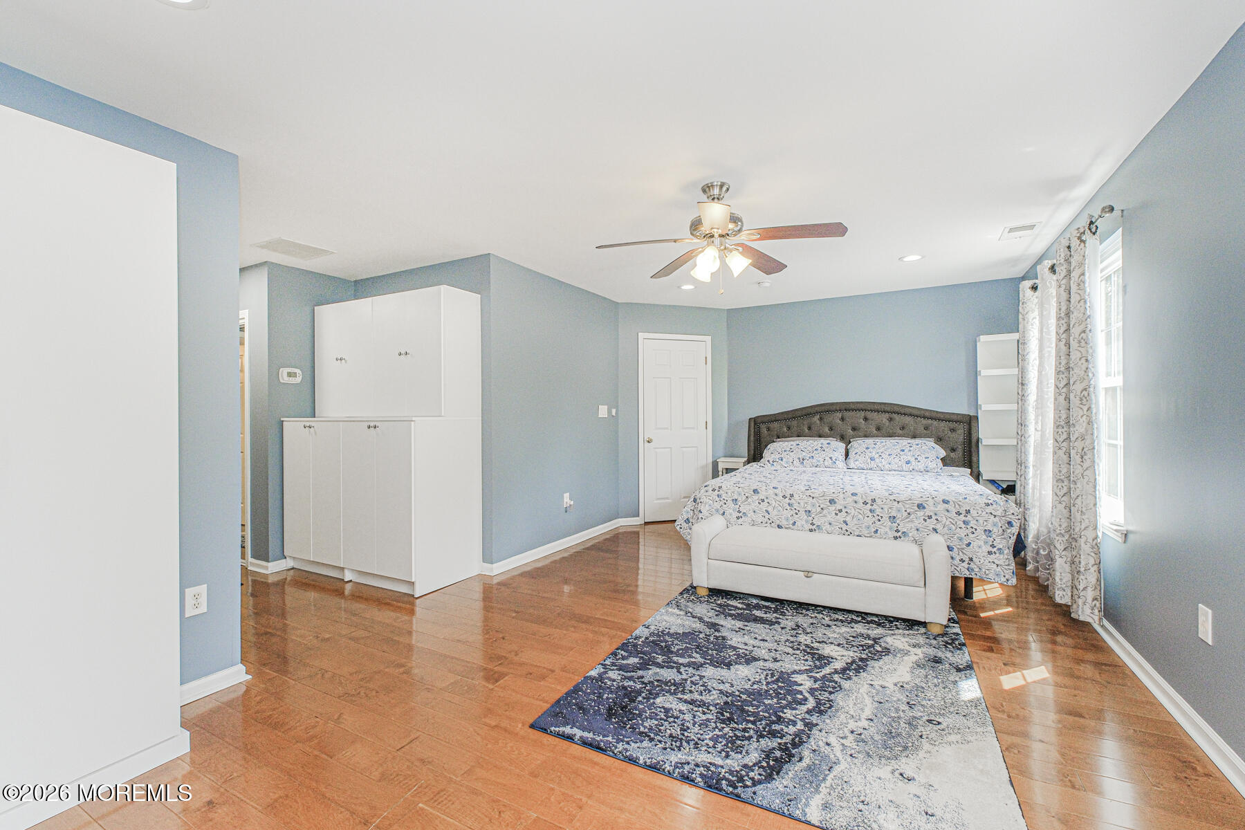 315 Wedgewood Road Morganville, NJ 07751 - Photo 30 of 37 a spacious bedroom with a bed and a chandelier