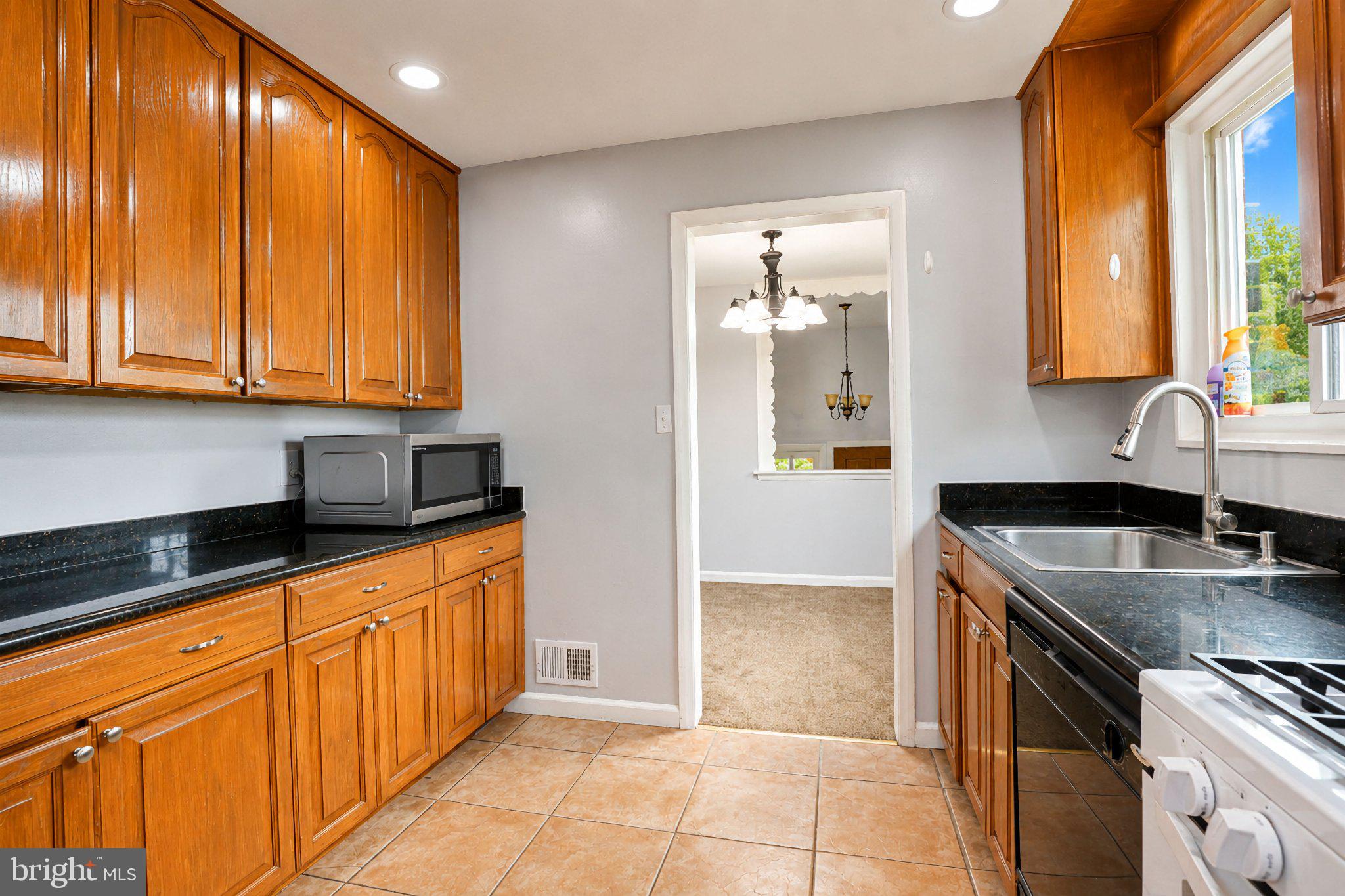 5712 Ash Drive Springfield, VA 22150 - Photo 11 of 38 Modern kitchen with warm wood accents.